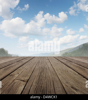 Pont de bois comme un vieux pays rustique paisible patio étage en perspective avec un ciel d'été sur une belle gamme de montagne avec les arbres forestiers comme un symbole de l'arrière-cour et voyage vie. Banque D'Images