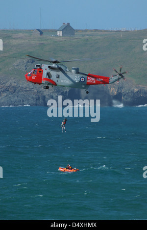 Une vraie vie de sauvetage de deux hommes qui avaient été coupées par la marée montante et ont été obligés de monter jusqu'à ce que les roches s'embourber. L'hélicoptère Sea King Banque D'Images