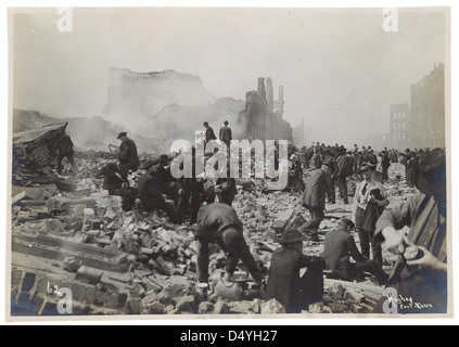 Cette photographie capture des chasseurs de souvenirs au lendemain du tremblement de terre de San Francisco de 1906, mettant en évidence la dévastation et la réaction chaotique alors que les gens récupéraient des objets dans les ruines. Banque D'Images