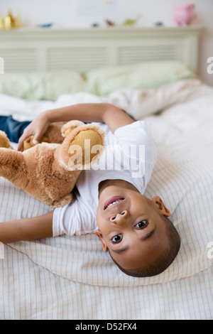 African American boy laying on bed Banque D'Images