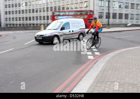 Les cyclistes et le trafic entrant dans un rond-point à Londres, Angleterre Banque D'Images