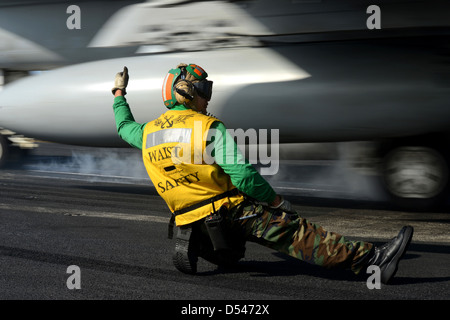 L'Aviation de l'US Navy maître de Manœuvre des signaux pour le lancement d'un aéronef à partir de la cabine de pilotage à bord du porte-avions USS John C. Stennis dans la mer d'Oman. Le Stennis fonctionne en soutien de la guerre en Afghanistan. Banque D'Images