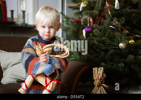 Boy holding toy by Christmas Tree Banque D'Images