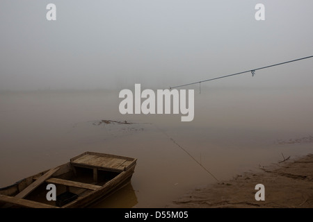 Un matin brumeux sur la rivière Beas avec bateau en bois et corde de bac sur l'eau dans le Pendjab en Inde Banque D'Images