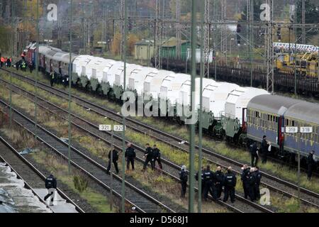 Les policiers habillés en tenue de se briser en se tenant debout à côté du train qui transporte le transport nucléaire Castor à Lehrte, près de Hanovre, Allemagne, 7 novembre 2010. La 12ème livraison de déchets nucléaires de l'usine de retraitement française de La Hague est sur le point d'arriver à l'installation de stockage provisoire de déchets nucléaires à Gorleben. Photo : Ralph Goldmann Banque D'Images