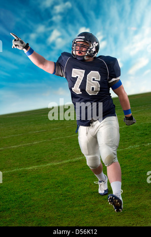 Caucasian football player cheering in game Banque D'Images