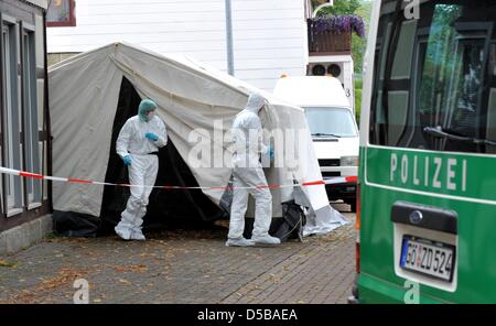 Les enquêteurs de quitter le lieu du crime où un garçonnet de cinq ans a été trouvé mort dans le district de Dellingen (Holzminden), Allemagne, 18 août 2010. Le cadavre a été retrouvé dans un garage à côté de la maison de la mère. L'enfant de cinq ans a disparu depuis le mardi après-midi (17 août). Photo : Jochen Luebke Banque D'Images