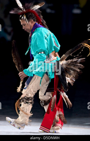 Une photographie vibrante d'un homme amérindien participant à un powwow en 2005, vêtu de regalia traditionnels avec des plumes d'aigle. Cette image capture l'esprit de la danse et de la culture amérindiennes. Banque D'Images