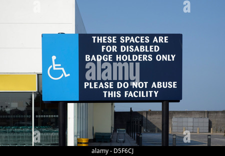 Un signe aux personnes à mobilité réduite Parking gratuit dans un parking de supermarché, uk Banque D'Images