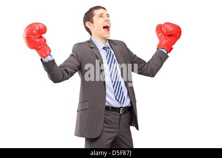 Happy young woman in suit with red boxing gloves gesturing bonheur isolé sur fond blanc Banque D'Images