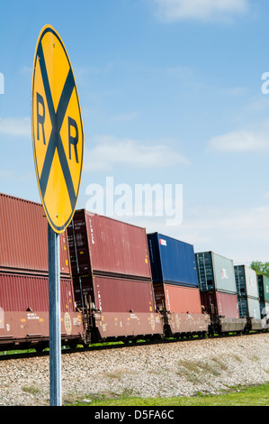 Railroad sign in front of a Burlington Northern Santa Fe Railway train transportant des conteneurs d'expédition, Jonesboro, Arkansas Banque D'Images