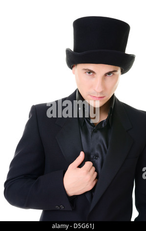 L'homme rigoureux sérieux illusioniste en costume noir et chapeau haut isolé sur fond blanc Banque D'Images