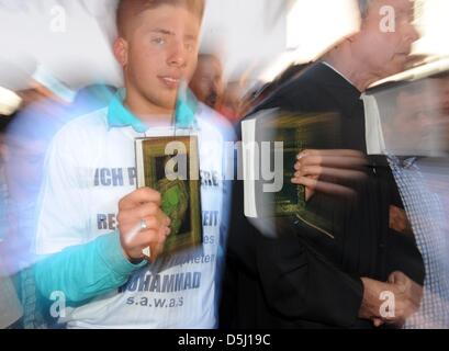 Un jeune homme détient le Coran au cours d'une manifestation contre un islam controversé vidéo dans Freiburg, Allemagne, 21 septembre 2012 (photo prise avec effet de zoom). Le film est à l'origine de protestations dans le monde entier. Photo : PATRICK SEEGER Banque D'Images