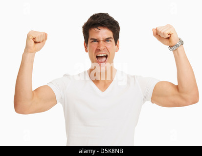 Studio portrait of handsome man cheering et flexing muscles Banque D'Images