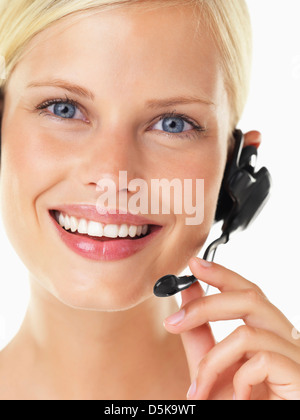 Studio portrait of young woman wearing headset Banque D'Images