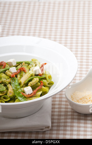 Cuisine italienne classique pâtes penne avec pesto de tomates et basilic Banque D'Images