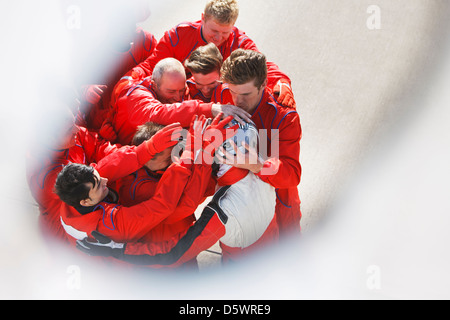 Racing team hugging racer au pit stop Banque D'Images