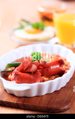 Haricots cuits au four avec saucisses grillées et œuf frit Banque D'Images