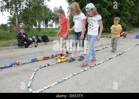 Les participants à un défi record du monde d'observer une ligne de petites voitures dans Pausa, Allemagne, 10 juin 2012. Selon le Club, la Trabant Pausa club a réussi à créer la plus longue ligne de petites voitures dans le monde avec 3100 véhicules miniatures et ce qui a brisé un record du monde. Photo : ELLEN LIEBNER Banque D'Images