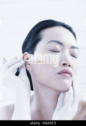Woman having botox injection en face