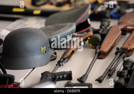 Les armes saisies et objets, parmi eux une croix gammée et des portraits d'Adolf Hitler, se coucher sur une table avant qu'une conférence de presse sur l'interdiction d'organisations extrémistes de droite à Stolberg près de Aix-la-Chapelle, Allemagne, 23 août 2012. Les objets ont été trouvés lorsque la police a attaqué des maisons dans les premières heures du matin. Photo : HENNING KAISER Banque D'Images