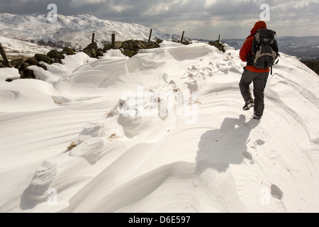 L'empreinte relevée dans les amoncellements de neige massives de bloquer l'Kirkstone Pass Road au-dessus de Ambleside dans le Lake District, Banque D'Images