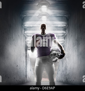 African American football player standing in hallway Banque D'Images