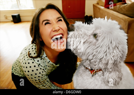 Dog licking Caucasian woman's face Banque D'Images