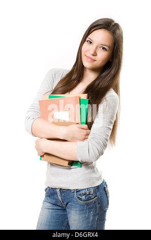Portrait of cute young brunette student holding exercise books. Banque D'Images