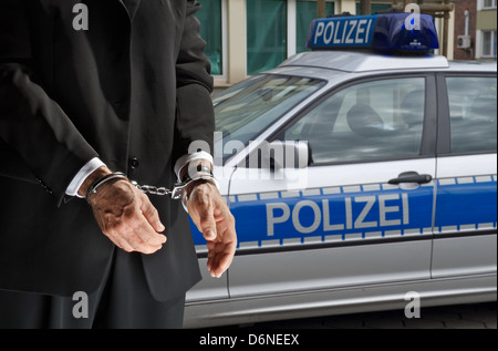 Hambourg, Allemagne, l'homme menotté devant une voiture de police Banque D'Images