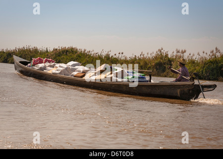 L'homme le transport du fret dans un bateau, le lac Inle, l'État de Shan, Myanmar (Birmanie), Banque D'Images