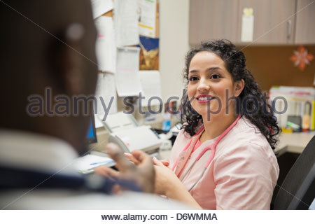 Jeune infirmière discuter avec son collègue en clinique