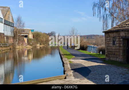 Les cyclistes sur les rives de la Leeds Liverpool Canal sur la banlieue de Leeds, West Yorkshire, Royaume-Uni Banque D'Images