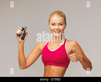 Woman with hand expander Banque D'Images