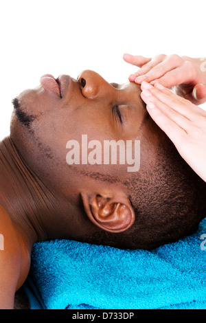 Black man recaiving head massage au spa, isolated on white Banque D'Images