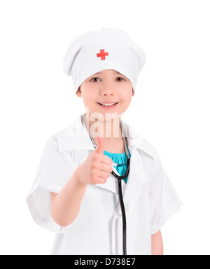 Portrait of a smiling little girl wearing comme un docteur à l'uniforme blanc, avec un stéthoscope, geste showing thumb up Banque D'Images