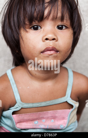 Adorable jeune fille vivant dans la pauvreté dans la région de Manille, aux Philippines. Banque D'Images