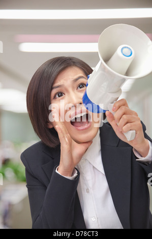 Young Businesswoman with Megaphone Banque D'Images