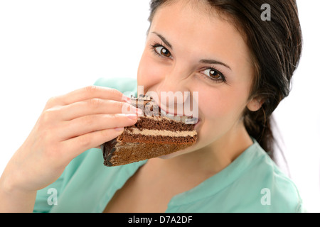 Greedy young woman eating tasty cake looking at camera Banque D'Images