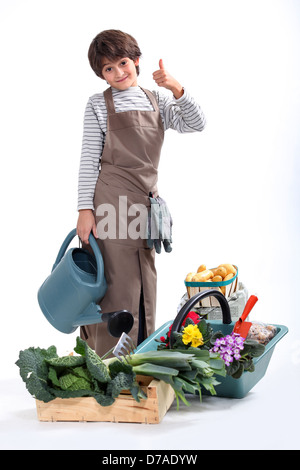 Un petit garçon habillé en jardinier Banque D'Images