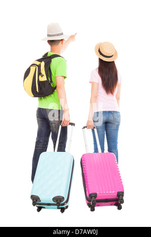 Jeune couple avec valise de voyage touristique et en pointant quelque chose Banque D'Images