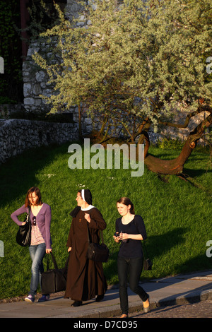 Nun et deux filles marcher par les murs du château de Wawel. Cracovie, Pologne Banque D'Images