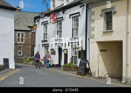 Deux femmes et un enfant en passant devant le Red Lion Inn, à Hawkshead, Parc National de Lake District, Cumbria, Angleterre, Royaume-Uni Banque D'Images