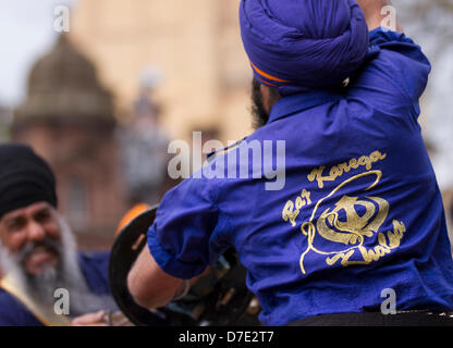 Khalsa Sikh arts martiaux (Armée des purs). Un guerrier de Nihang ou Sikh interprète Gatkha, Gatka une tradition en utilisant la démonstration de voile de Chakra à la plus importante célébration de Vaisakhi dans le calendrier sikh marqué par la communauté sikh du Grand Manchester, avec leur procession annuelle Nagar Kirtan dans les rues de la ville. Le Nagar Kirtan est la couleur, la célébration et le culte et est une invitation à tous, indépendamment de la caste, de la religion et de la croyance, de se joindre aux Sikhs pour célébrer leur religion et leur culture. Banque D'Images