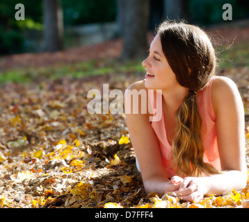 Teenage girl appréciant les feuilles d'automne Banque D'Images