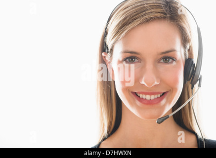 Studio portrait of young woman wearing headset Banque D'Images