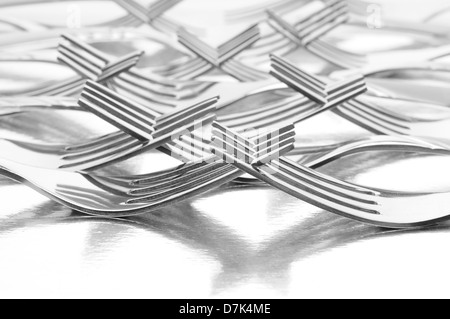 Groupe des fourches avec leurs dents étroitement liée à la réflexion sur une surface en métal brillant. Format horizontal Banque D'Images