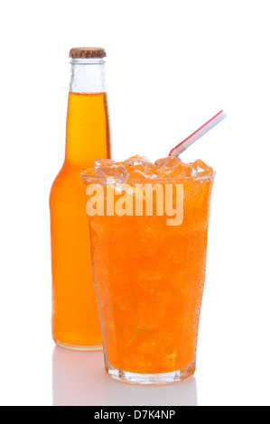 Un verre de soda à l'orange rempli de glace et une paille à boire, avec une bouteille au derrière. Banque D'Images