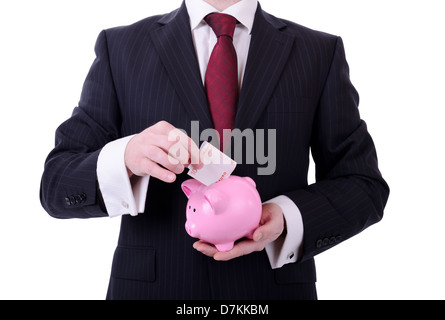 Businessman putting a 10 euro note dans une tirelire, concept de l'épargne isolated on white Banque D'Images