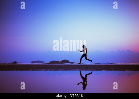 Contexte Le sport, faire de fin, silhouette de femme sur la plage Banque D'Images